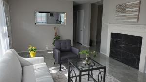 a living room with a couch and a chair and a fireplace at The Mall of America(MOA) House in Bloomington