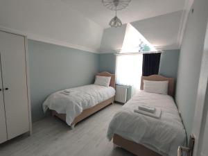 a bedroom with two beds and a window at Penthouse in Trabzon