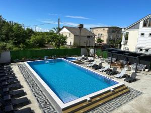 a swimming pool with chaise lounge chairs next to it at Hotel Lion in Ureki