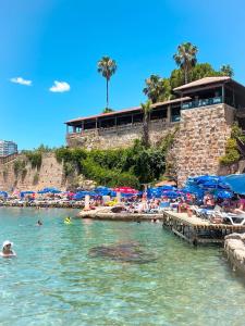 a group of people in the water at a beach at Royal Hayat Hotel Old Town in Antalya