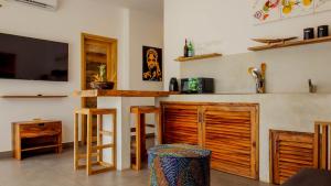 a kitchen with a counter and a bar with a tv at CDM Villas Kiwengwa in Kiwengwa