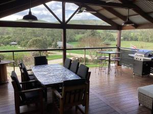 a screened in porch with a table and chairs at Strath Creek Station farm-stay in Strath Creek