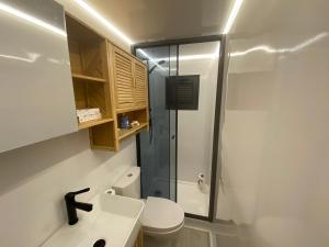 a bathroom with a toilet and a sink and a shower at Houseboat Cádiz El Puerto - Casa Flotante in El Puerto de Santa María