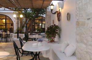 two tables and chairs in a restaurant with tables at Bungalows Svoronos in Naousa