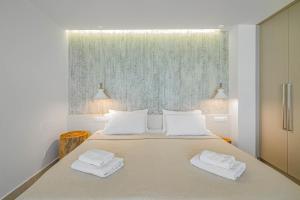 a bedroom with a bed with two towels on it at Junior suite by the beach Stalida in Stalida