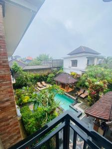 a view of a pool from a balcony of a house at Nami House in Ubud