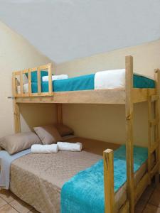 two bunk beds in a room with a bed at Casa Aguacate in Antigua Guatemala