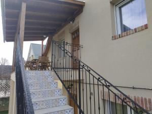 a stairway with a railing next to a building at BBFamily in Balatonboglár