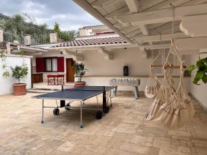 a ping pong table in the middle of a patio at Al Piglio Maison de Charme in Piglio