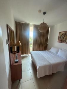 a bedroom with a large bed and a window at Daissy house - דירה פרטית בנאות גולף in Caesarea