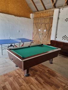 two ping pong tables in a room with two tables at Leśniczówka nad jeziorem in Zamordeje