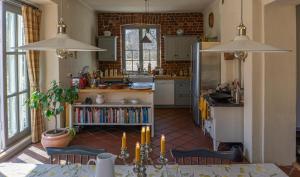 a kitchen with a table and chairs in a room at Villa Kingfisher in Åminnefors +5 photos