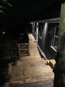 a pathway leading to a building at night at Hermon chapel. in Wrexham