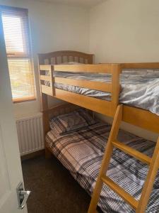 a bedroom with two bunk beds and a window at Hermon chapel. in Wrexham
