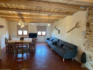 a living room with a blue couch and a table at Casa Vicent in Alcanar