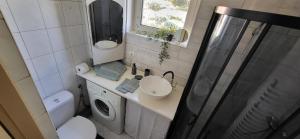 a bathroom with a toilet and a sink and a shower at Szpitalna 9c in Suwałki