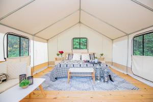 a room with a bed in a tent at Experience Nature Glamping - Roaring River in Cassville