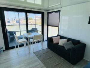 a living room with a couch and a table at Houseboat Cádiz El Puerto - Casa Flotante in El Puerto de Santa María