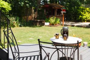 a table with two chairs and two cups of coffee on it at Yellow Door in Cheltenham