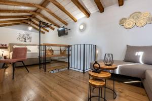 a loft apartment with a bed and a living room at Samis Pelion LuxuryLiving in Portaria