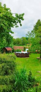 a park with a fountain in the middle of a field at Wiejska Sielanka noclegi Ustroń in Ustroń