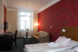 Postel nebo postele na pokoji v ubytování Hotel Vacek Pod Věží