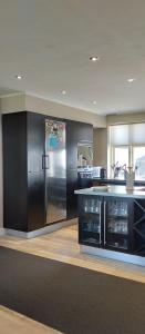 a kitchen with a stainless steel refrigerator and a counter at Den Hvide Farm in Skanderborg