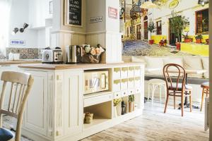 a kitchen with a counter and chairs in a restaurant at 5 Vintage Guest House in Sofia
