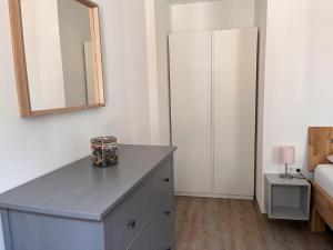 a bedroom with a dresser and a mirror at Ferienhaus Heinrich in Ediger-Eller +7 photos