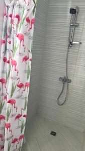 a shower curtain with flamingos on it in a bathroom at GUEST HOUSE ZORNICA in OBZOR in Obzor