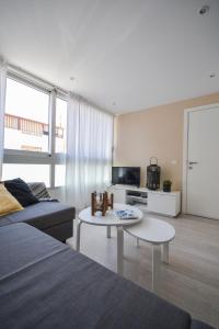 a living room with a couch and a table at Luminoso loft recién reformado in La Playa de Arguineguín