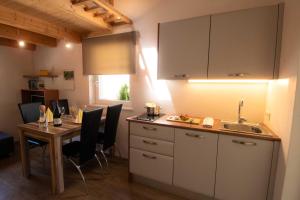 a kitchen with a table and a sink at Melanies Guesthouse 2 Zimmerwohnung in Caldaro
