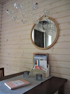 a table with a mirror and books on it at LevonMajat in Joensuu