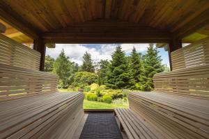 a wooden pavilion with a view of a garden at Alpejski Boutique Hotel in Karpacz
