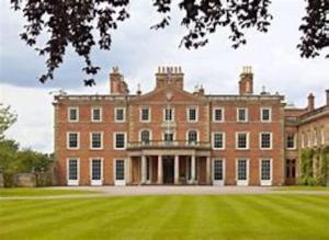 a large brick building with a large grass yard at Lynn Cottage, Newport in Newport