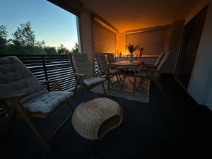 a balcony with chairs and a table and a dining room at Mobile home Mare Blu in Rovanjska