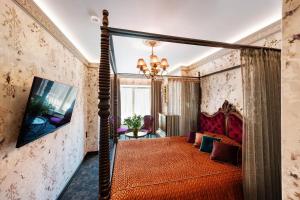 1 dormitorio con cama con dosel en una habitación en Sofijos Rezidencija, en Birštonas