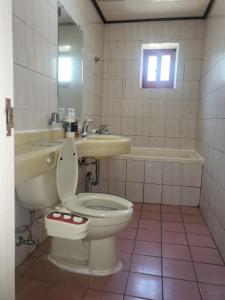 a bathroom with a toilet and a sink and a tub at Songwol Park in Sokcho