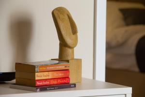 a wooden object sitting on top of a stack of books at Apartment Kirinkin in Vis