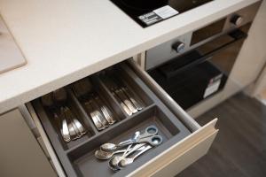 a drawer with scissors and utensils in a kitchen at Leeway Lodge in Church Coppenhall