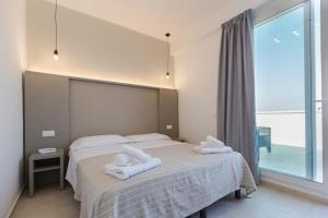 Postel nebo postele na pokoji v ubytování Hotel Altamarea