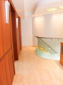 a hallway with a glass staircase in a building at Luxury Breathtaking Seafront Penthouse Duplex in Rishon LeẔiyyon