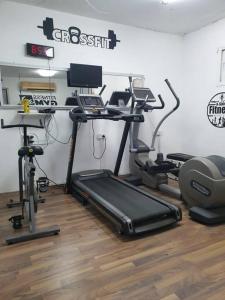 a room with a gym with a treadmill and exercise equipment at Luxury Breathtaking Seafront Penthouse Duplex in Rishon LeẔiyyon