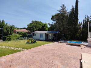 a backyard with a house and a yard with a house at Naturalayos con jacuzzi privado in Pelayos de la Presa