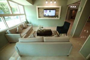a living room with a couch and a tv at RED SEA HOTEL - فندق ريد سى in Suez