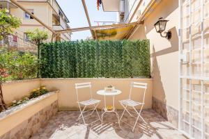 a small patio with a table and chairs on a balcony at Joker House Roma in 15 minuti Station Airport in Ciampino