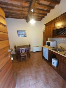 a kitchen with a table and a dining room at Fattoria Il Giardo in Pietrasanta