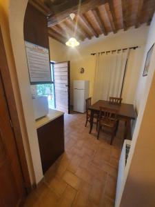 a kitchen and dining room with a table and a dining room at Fattoria Il Giardo in Pietrasanta