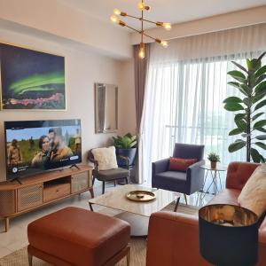 a living room with a couch and a tv at 3Br Sky House BSD Apartment Brandnew and Cozy in Samporo