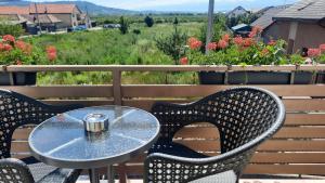 a table and chairs on a patio with flowers at *Studio David* in Sibiu